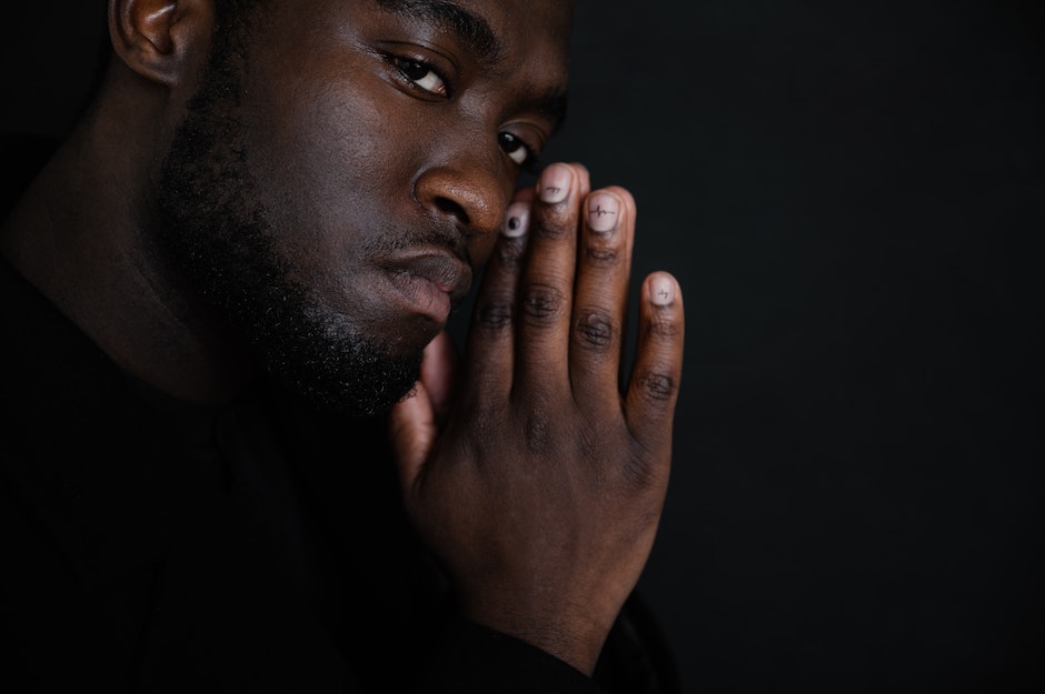 Black man with hands folded