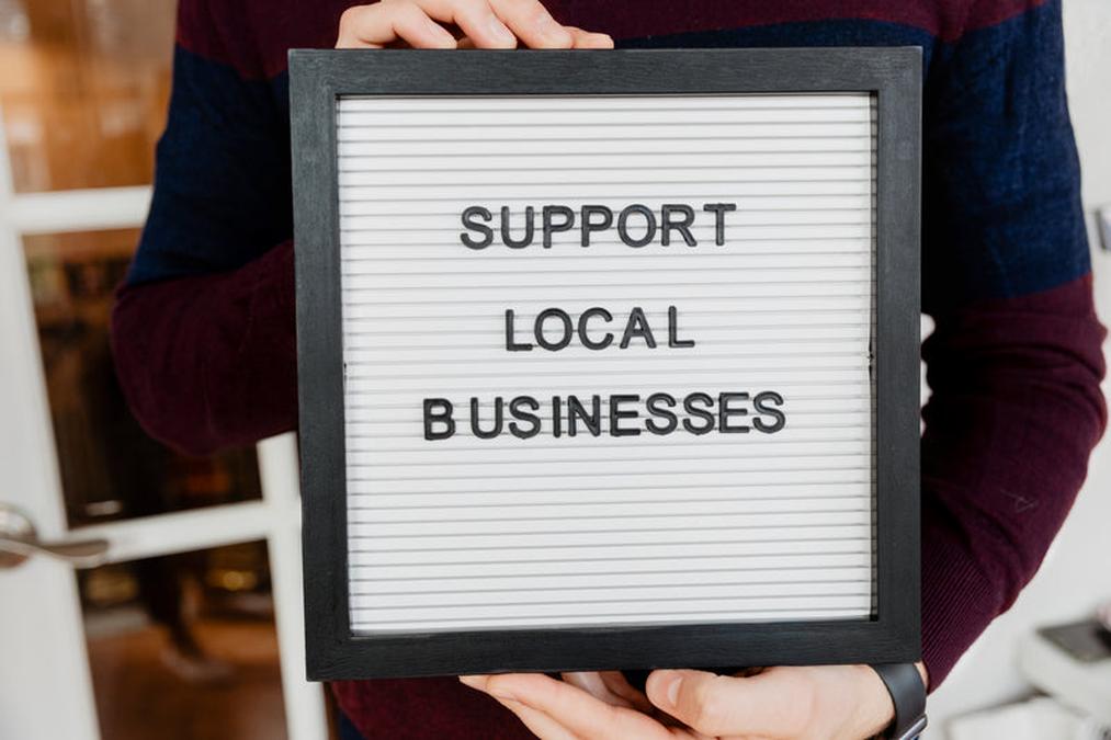 a person holding a sign that says support to local local local local local local local local local l