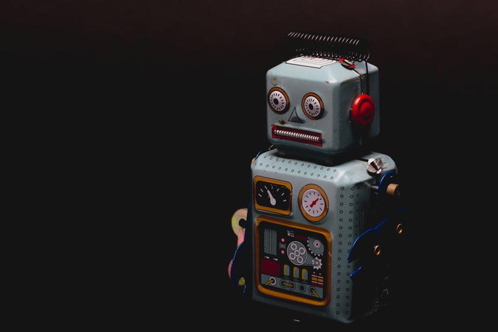 robot standing in dark - a robot toy with a clock and a clock